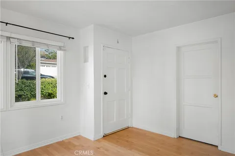 a view of a room with wooden floor and windows