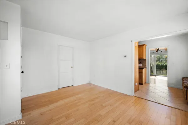 a big room with wooden floor and windows