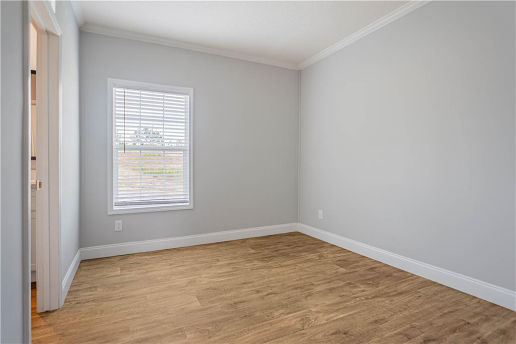210 Ridge Road Seale, AL 36875 - Photo 15 of 16 Wood-finish flooring, light grey wall paint, and white trim