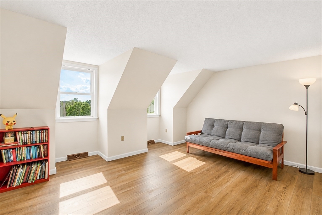 53 Century Way, Unit 53 Gardner, MA 01440 - Photo 12 of 22 a living room with furniture and a book shelf