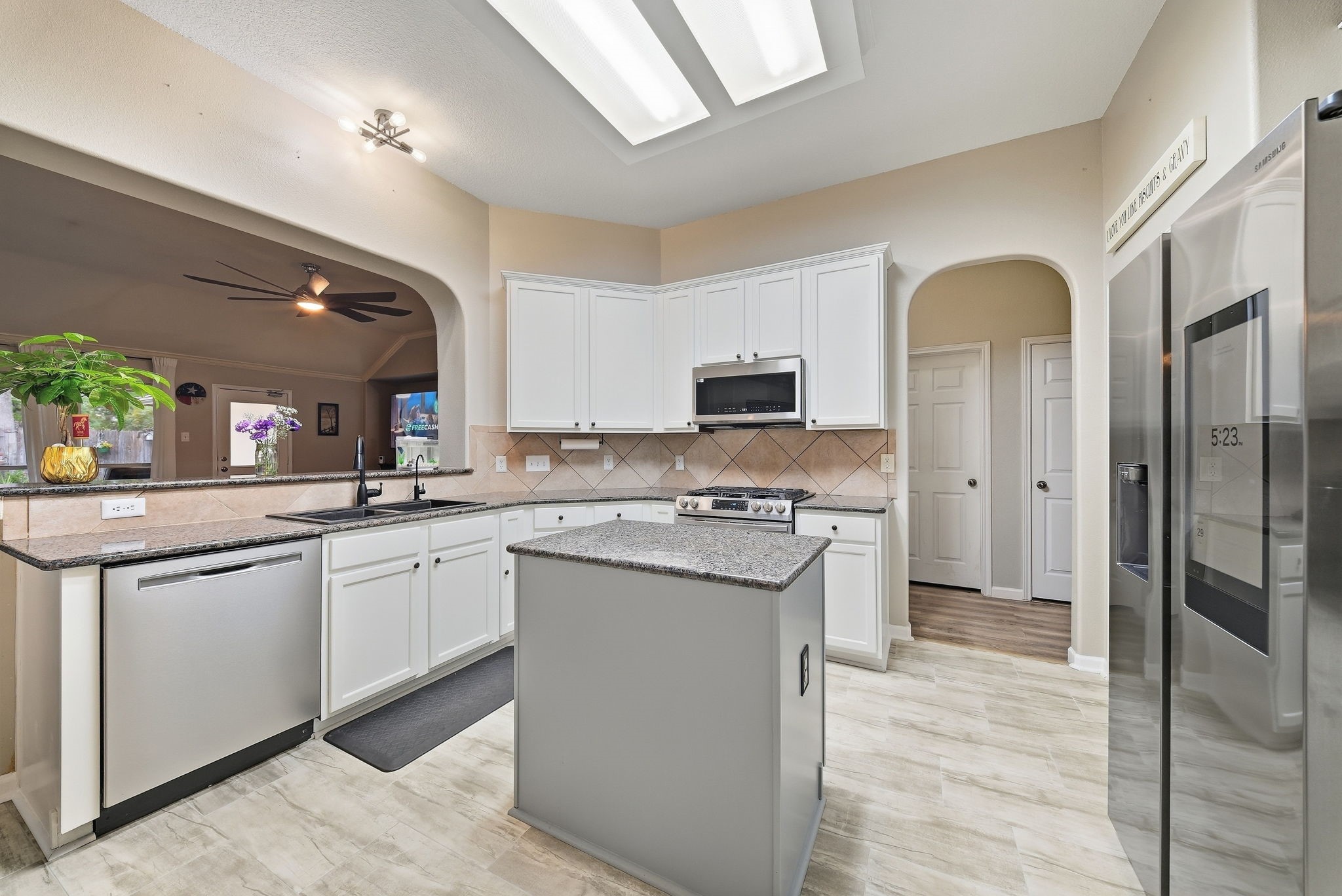 2223 Lazy Trail Path Court Spring, TX 77373 - Photo 7 of 23 Spacious kitchen with modern appliances, sleek countertops, and a central island, perfect for culinary enthusiasts.