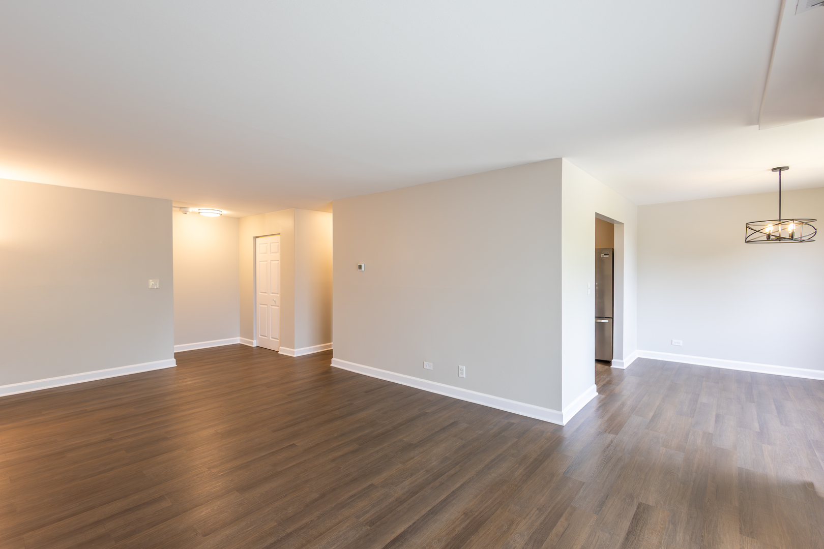 450 Raintree Court, Unit 2B Glen Ellyn, IL 60137 - Photo 5 of 28 a view of an empty room with wooden floor