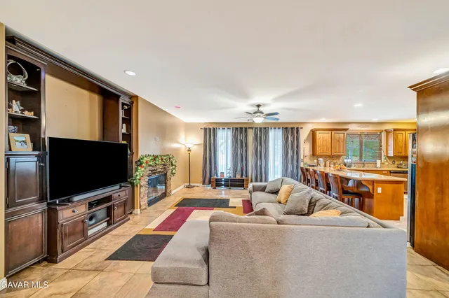 a living room with furniture and view of kitchen