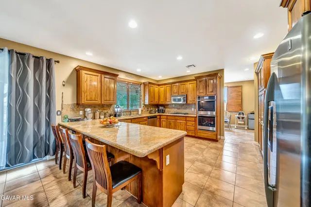 a spacious bathroom with a granite countertop sink a mirror and a shower
