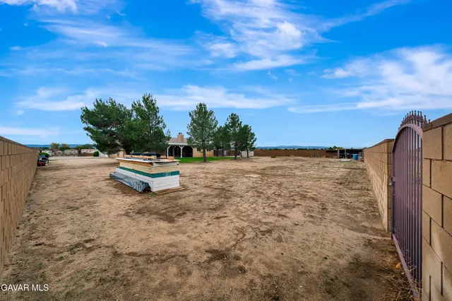 an aerial view of a house with a yard and plants