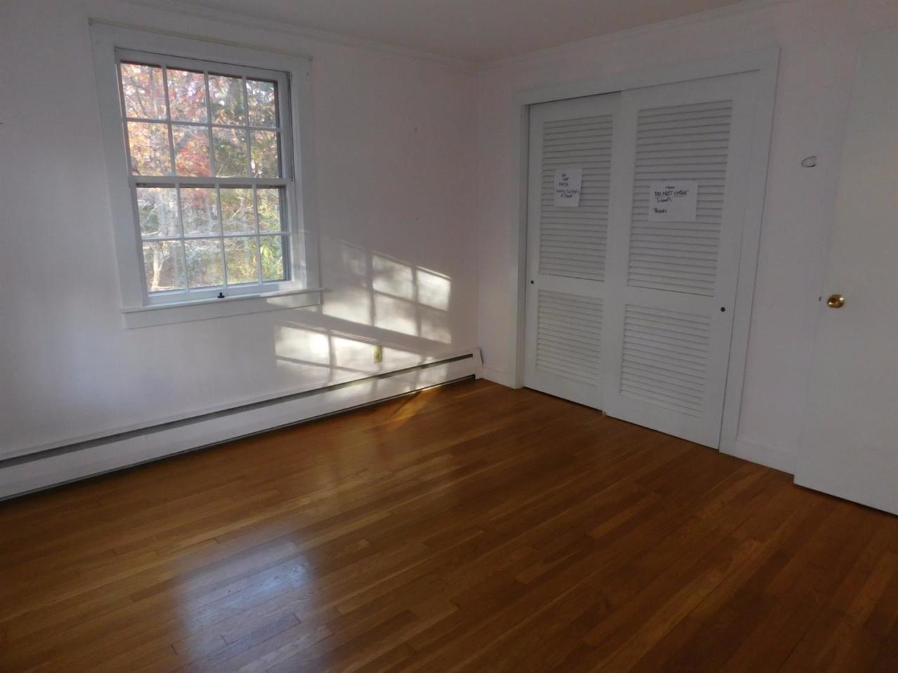173 Lumbert Mill Road Centerville, MA 02632 - Photo 14 of 17 an empty room with wooden floor and windows