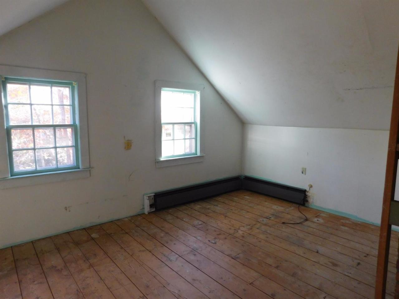 173 Lumbert Mill Road Centerville, MA 02632 - Photo 17 of 17 an empty room with wooden floor and windows