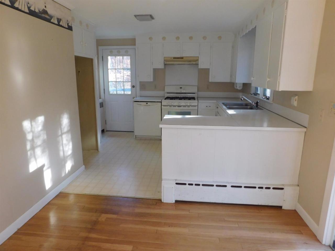 173 Lumbert Mill Road Centerville, MA 02632 - Photo 4 of 17 a view of a kitchen with a sink cabinets and wooden floor