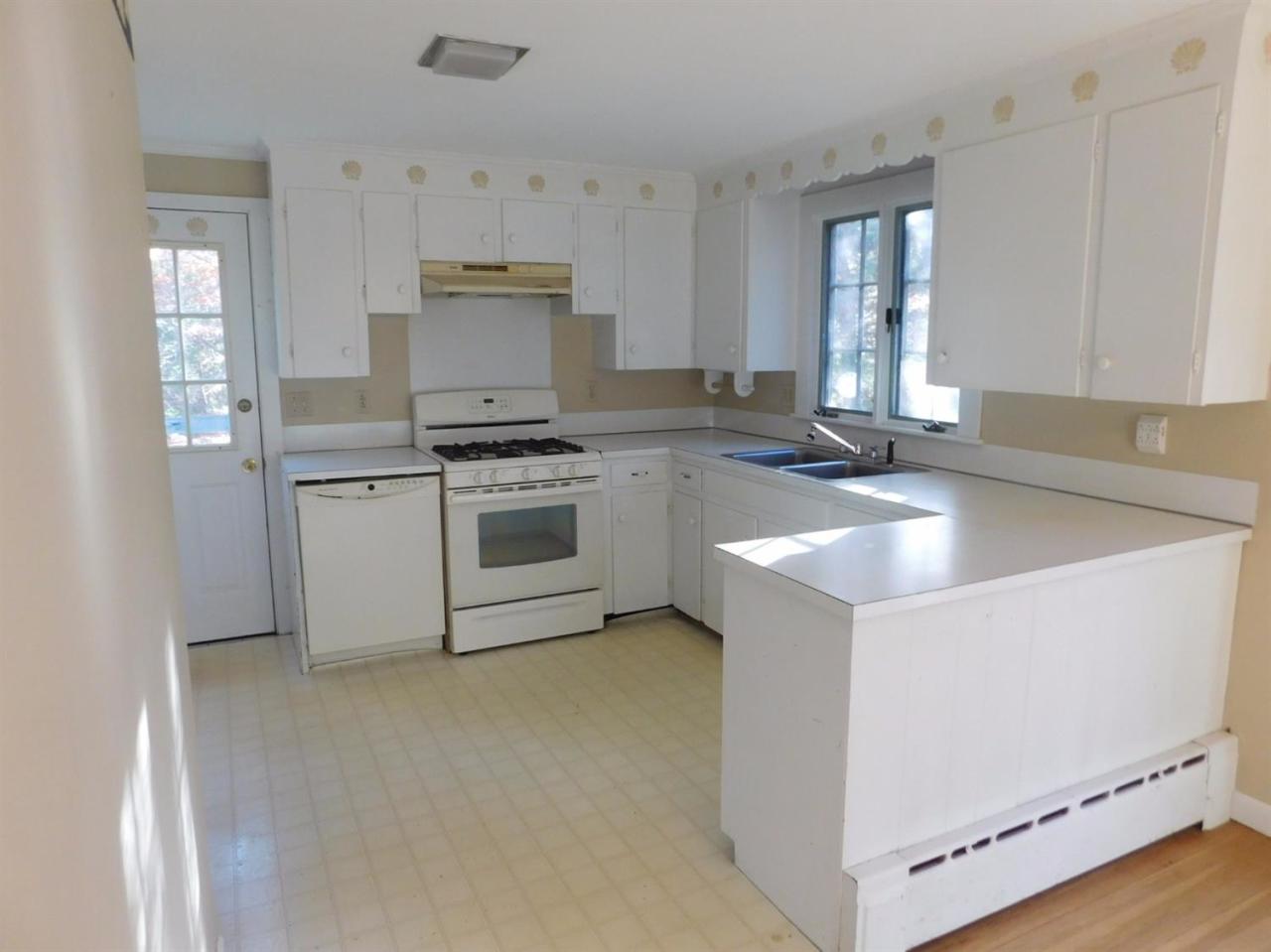 173 Lumbert Mill Road Centerville, MA 02632 - Photo 5 of 17 a kitchen with a stove and a sink