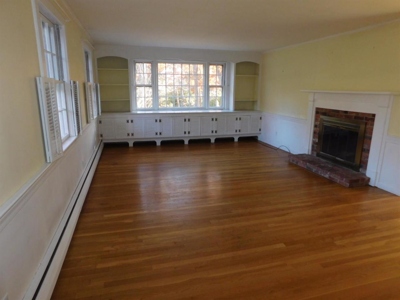173 Lumbert Mill Road Centerville, MA 02632 - Photo 8 of 17 an empty room with wooden floor and windows