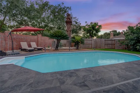 a view of a backyard with a chair and table