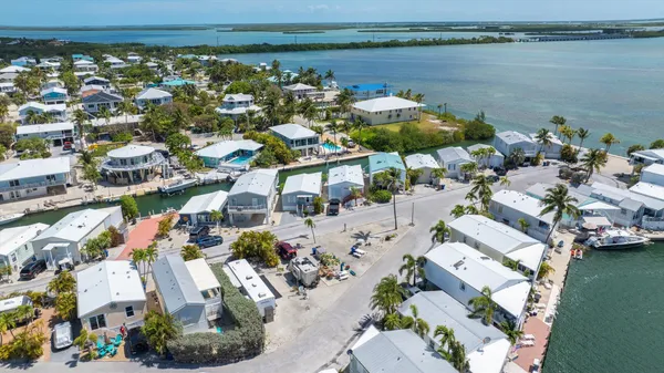 a tennis court that has a table and chairs