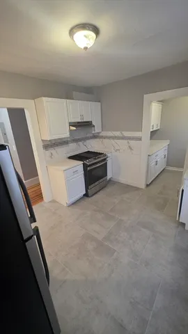 a kitchen with stainless steel appliances a stove and more cabinets