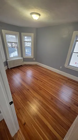 wooden floor in an empty room with windows