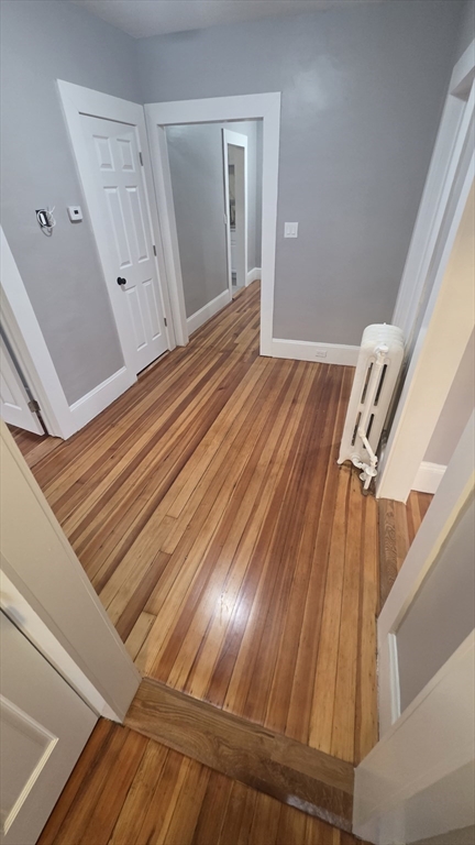 10 Itasca Street, Unit 3 Boston, MA 02126 - Photo 6 of 14 a view of a room with wooden floor