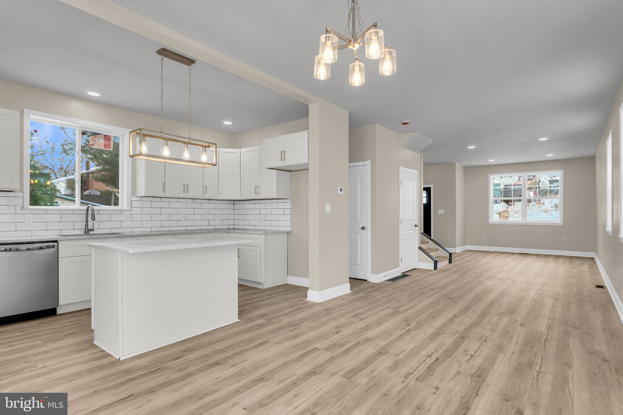 1716 Liggett Avenue Reading, PA 19607 - Photo 7 of 20 a kitchen with stainless steel appliances granite countertop a refrigerator a sink dishwasher a stove and white countertops with wooden floor