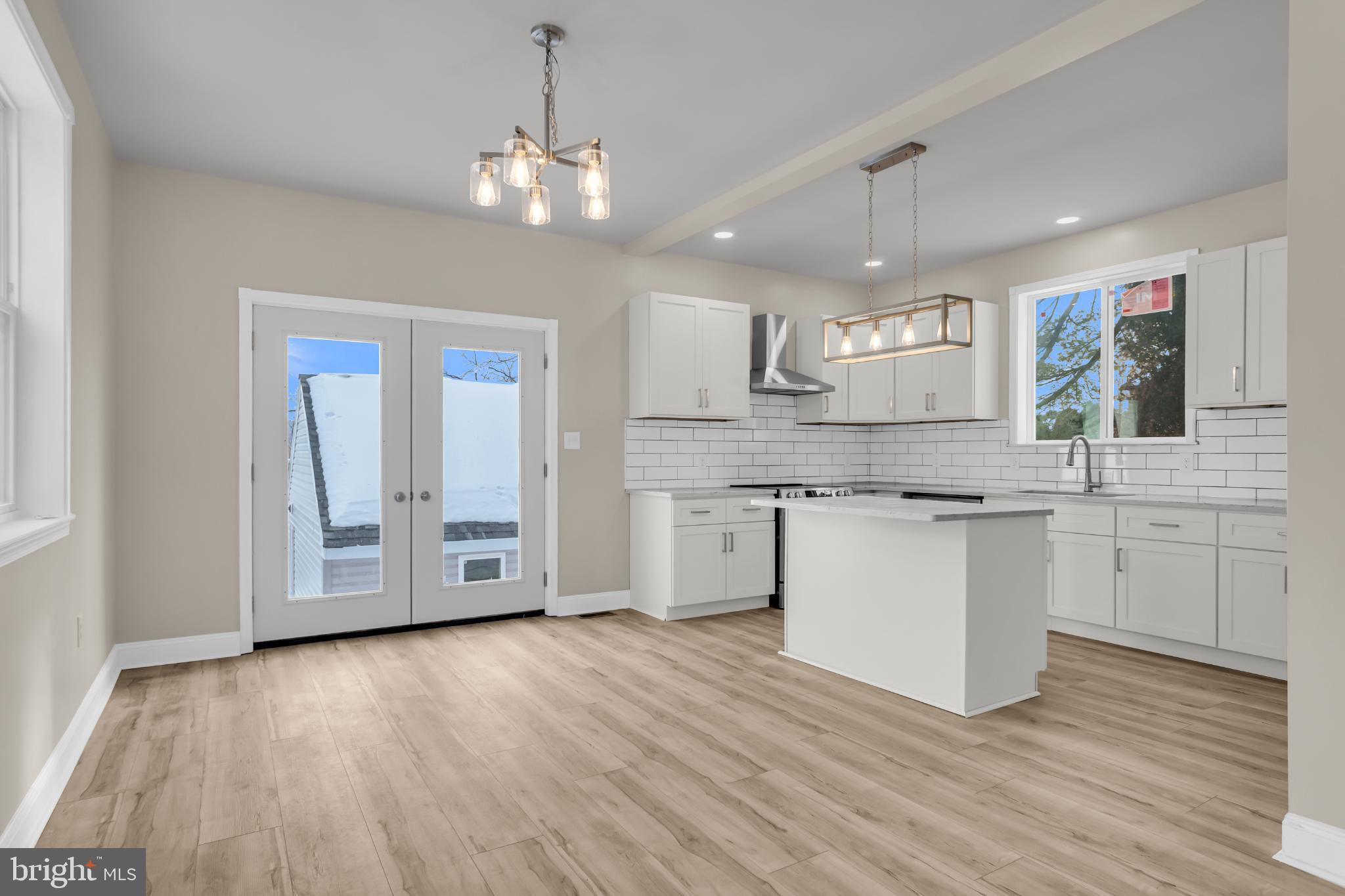 1716 Liggett Avenue Reading, PA 19607 - Photo 8 of 20 a large white kitchen with a white countertops a sink and a stove with wooden floor