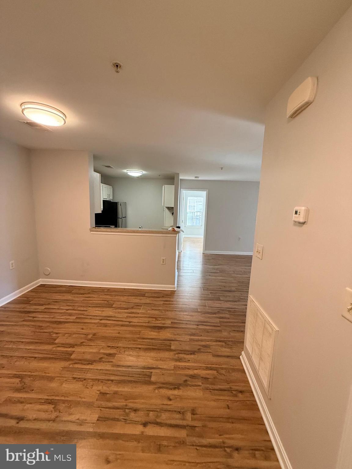 13621 Garfield Place, Unit 102 Woodbridge, VA 22191 - Photo 7 of 14 a view of empty room with wooden floor