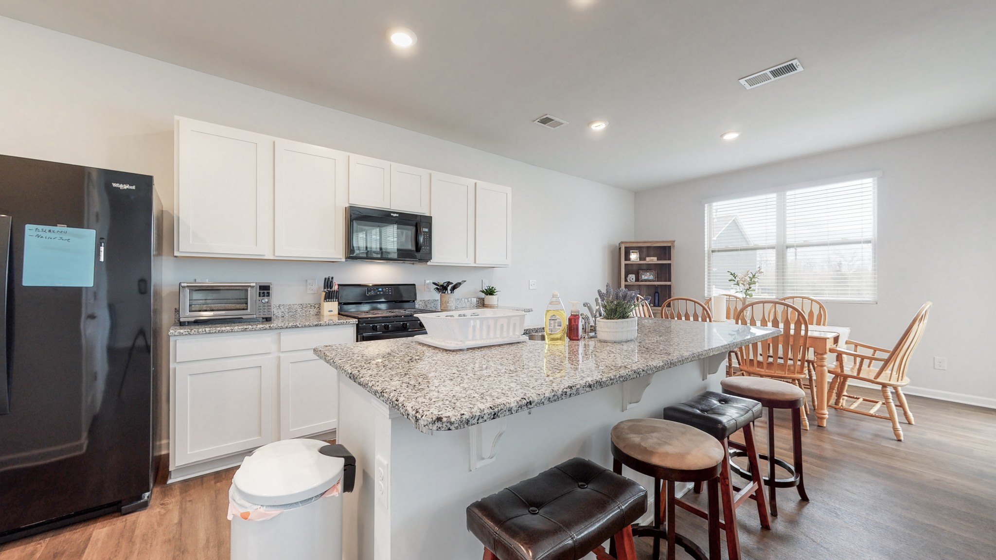 8012 Craighead Drive Lebanon, TN 37087 - Photo 7 of 53 a kitchen with granite countertop kitchen island a table and a sink