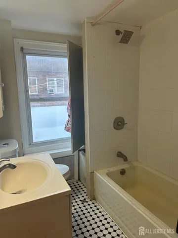 a bathroom with a sink a bathtub and a shower