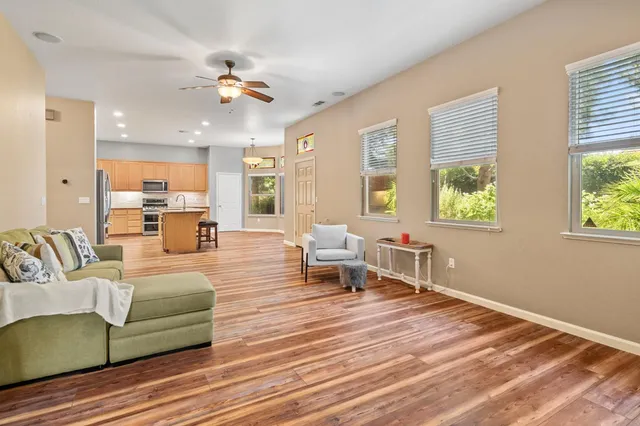 a living room with furniture and a chandelier