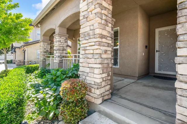 a front view of a house with a garden