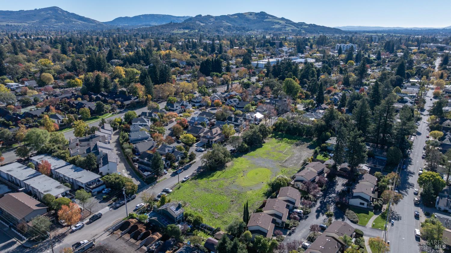1055 Wright Street Santa Rosa, CA 95404 - Photo 7 of 20 an aerial view of green landscape with trees houses and mountain view