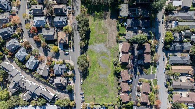 an aerial view of residential houses and outdoor space