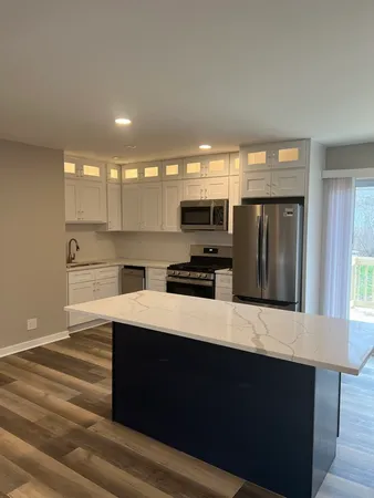 a kitchen with stainless steel appliances a refrigerator sink and microwave