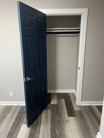 a view of closet with wooden floor