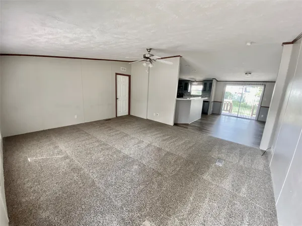 a view of a kitchen with a sink and refrigerator