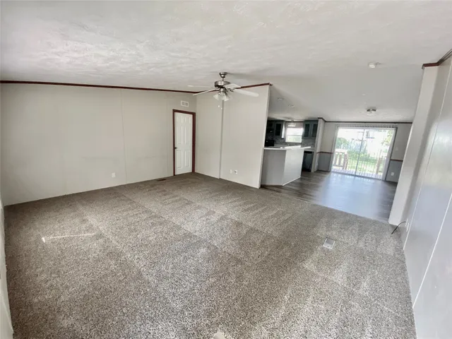 a view of a kitchen with a sink and refrigerator