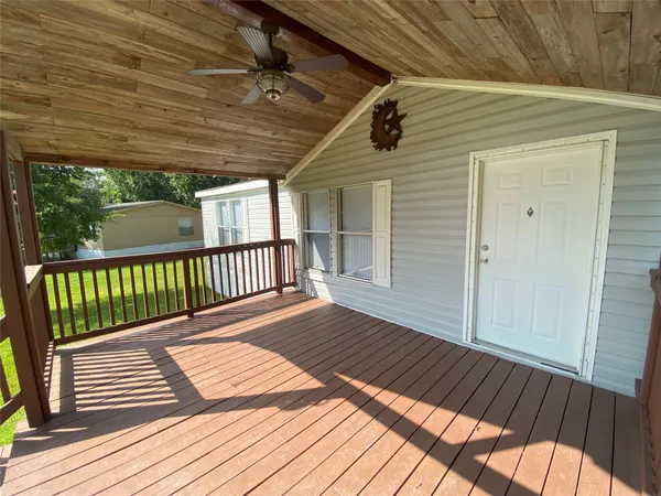 a view of balcony with wooden floor