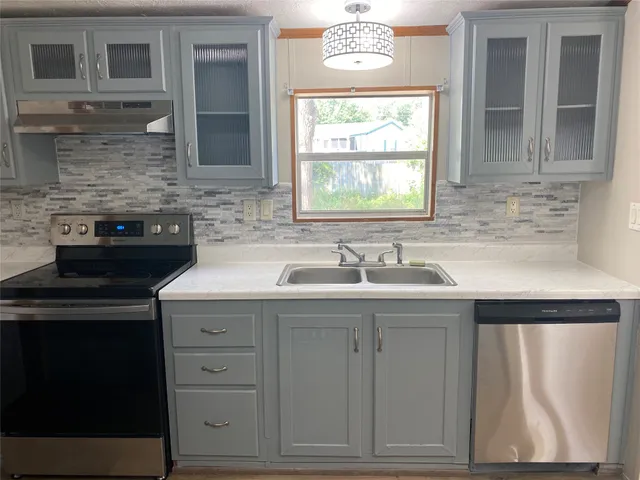 a kitchen with a sink and cabinets