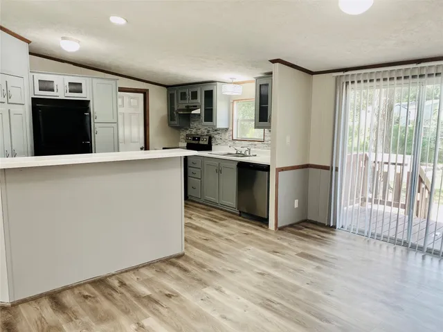a kitchen with stainless steel appliances granite countertop a refrigerator and a sink