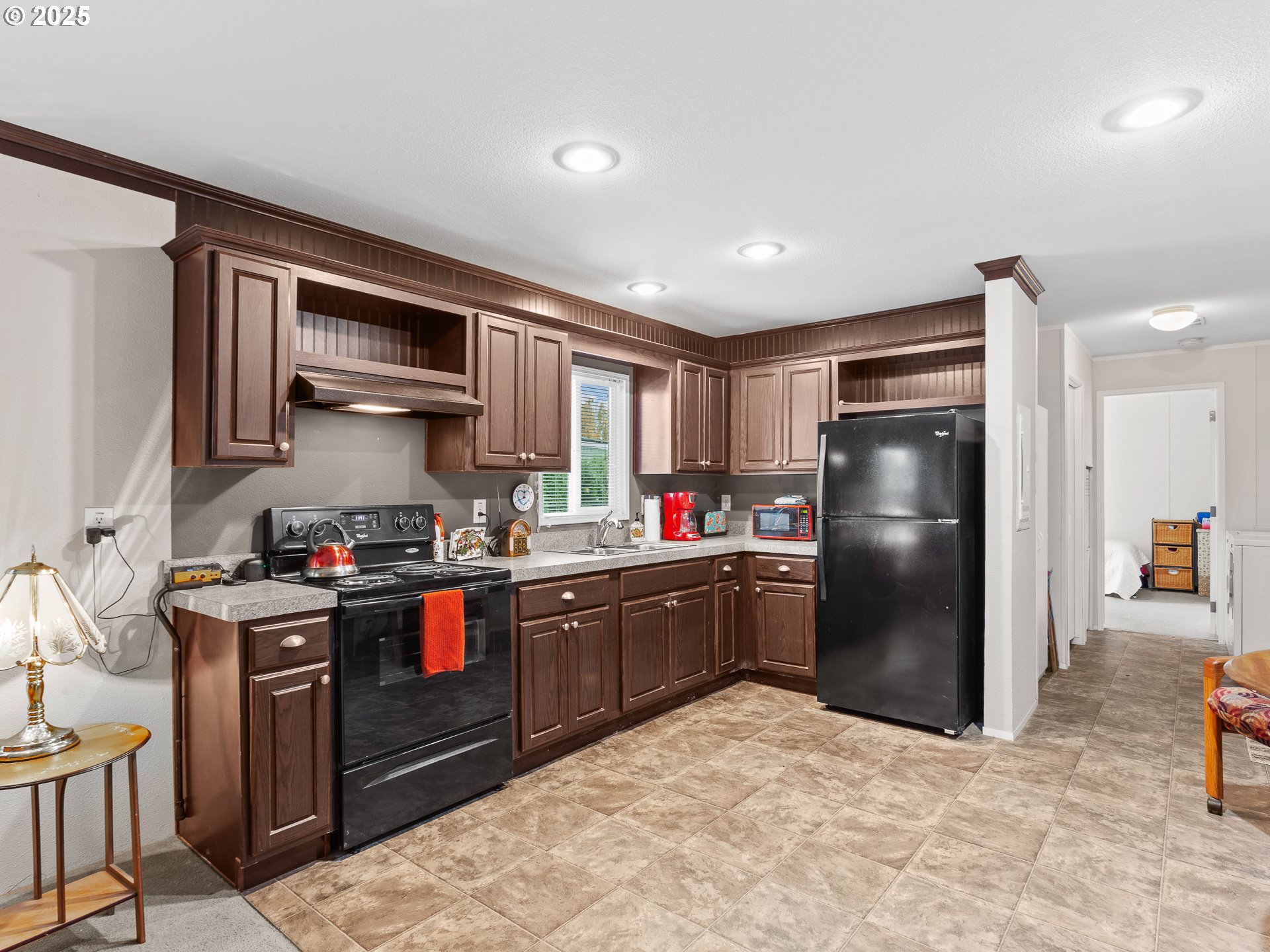 2901 East 2nd Street, Unit 121 Newberg, OR 97132 - Photo 15 of 48 a kitchen with stainless steel appliances granite countertop a refrigerator and a stove top oven