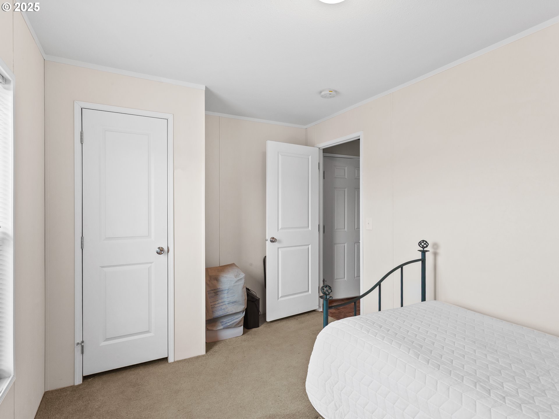 2901 East 2nd Street, Unit 121 Newberg, OR 97132 - Photo 20 of 48 a bedroom with a bed and a cabinet