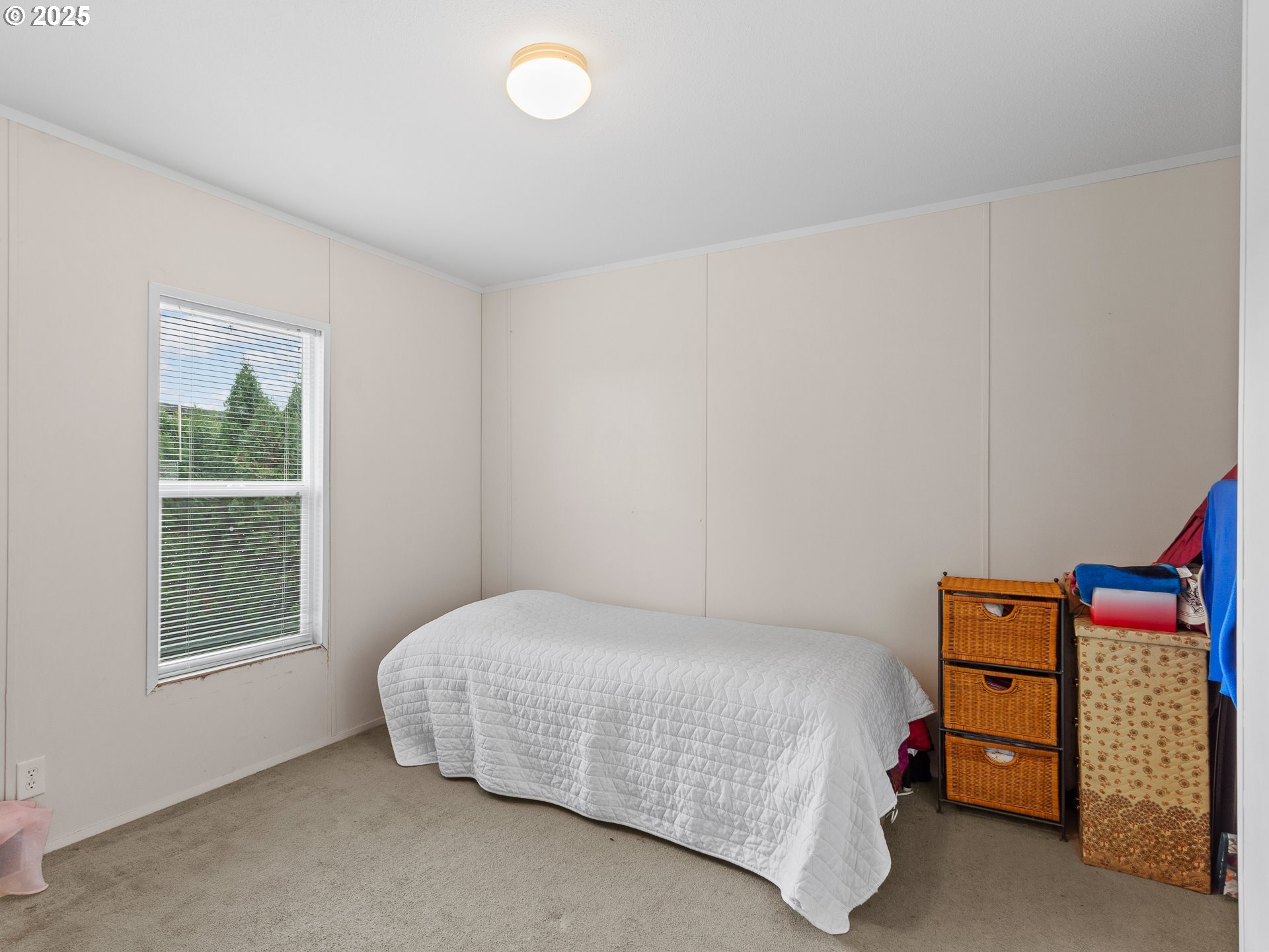 2901 East 2nd Street, Unit 121 Newberg, OR 97132 - Photo 24 of 48 a bedroom with a bed and a window