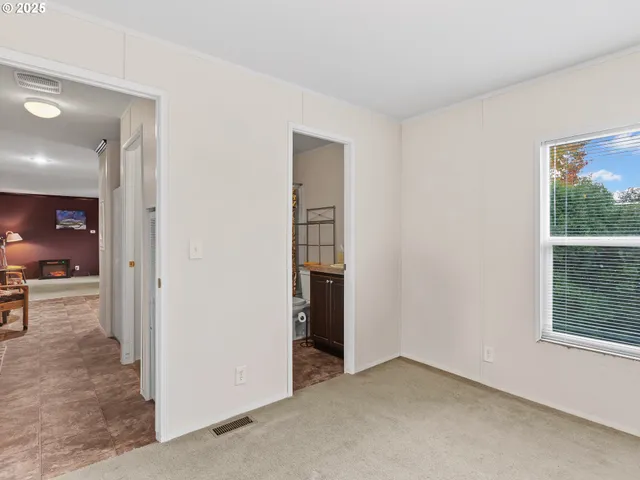 an empty room with windows and entrance