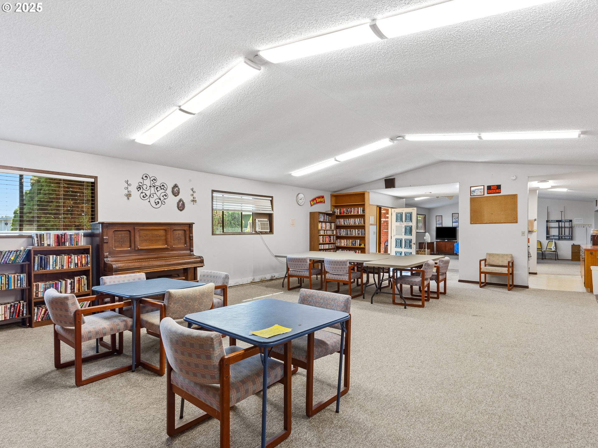 2901 East 2nd Street, Unit 121 Newberg, OR 97132 - Photo 36 of 48 a living room with furniture and a flat screen tv with kitchen view