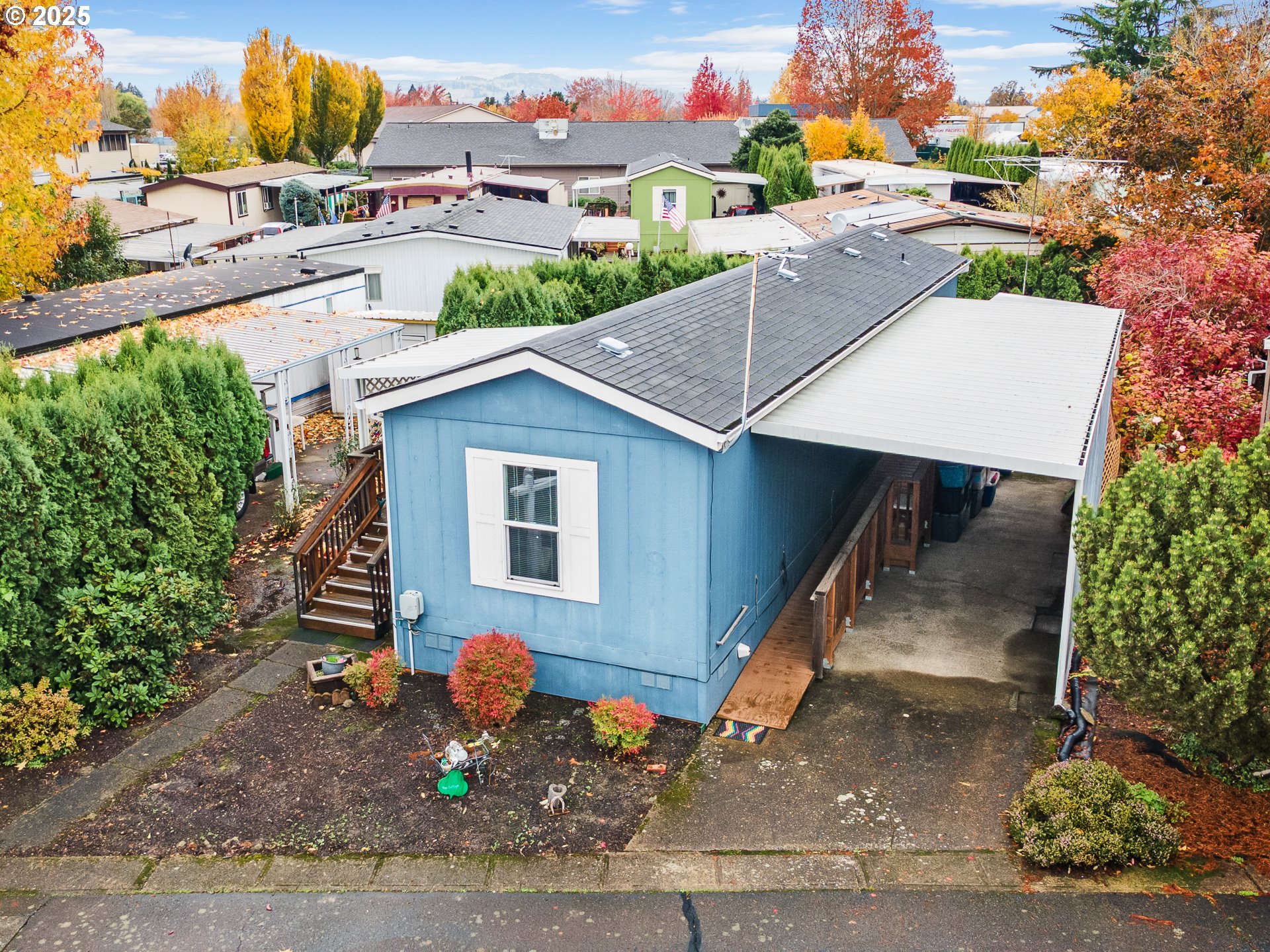 2901 East 2nd Street, Unit 121 Newberg, OR 97132 - Photo 9 of 48 a front view of a house with a yard and outdoor seating
