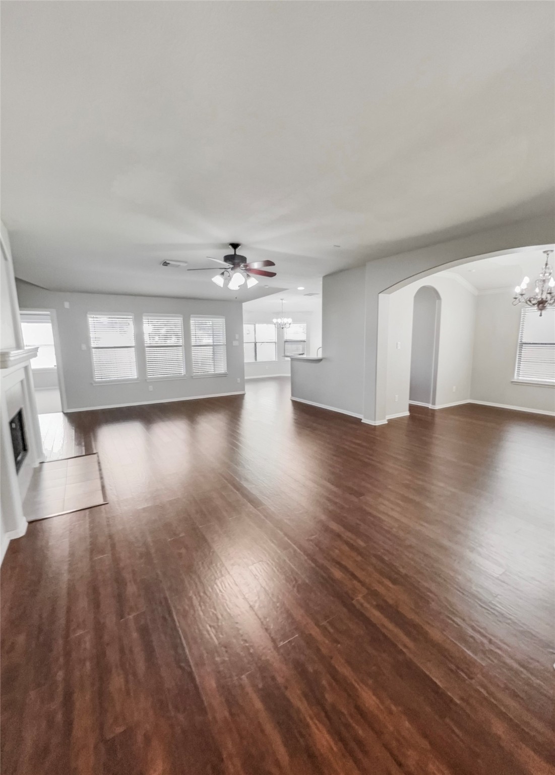 20326 Linshire Drive Spring, TX 77388 - Photo 3 of 24 Bright recessed lighting and tall windows with faux-wood blinds accent the openness and inviting living room that is central to the home.
