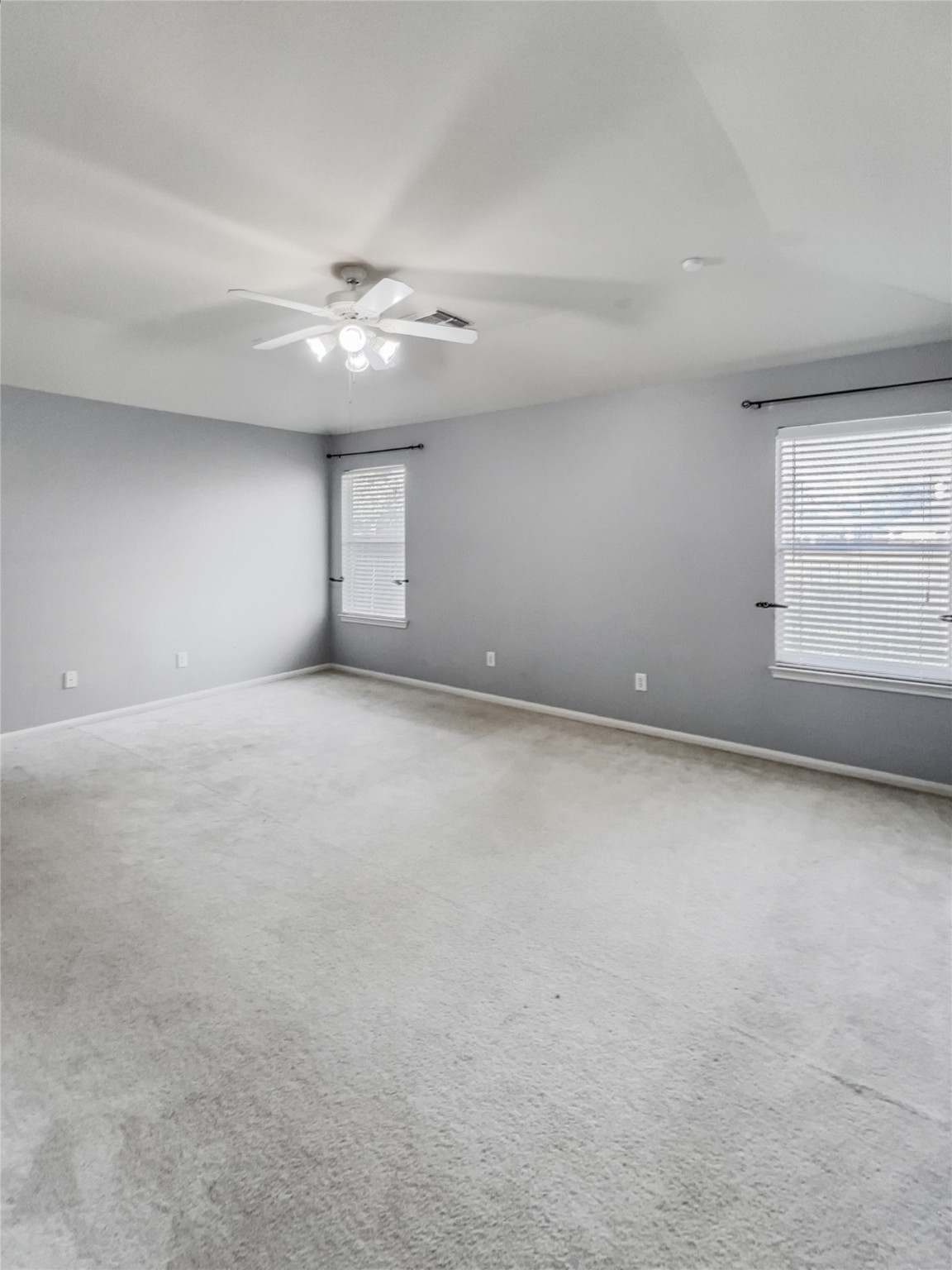20326 Linshire Drive Spring, TX 77388 - Photo 10 of 24 Oversized primary bedroom with large windows adorned with faux- wood blinds provide plenty of light and a peaceful view of the lake & backyard.