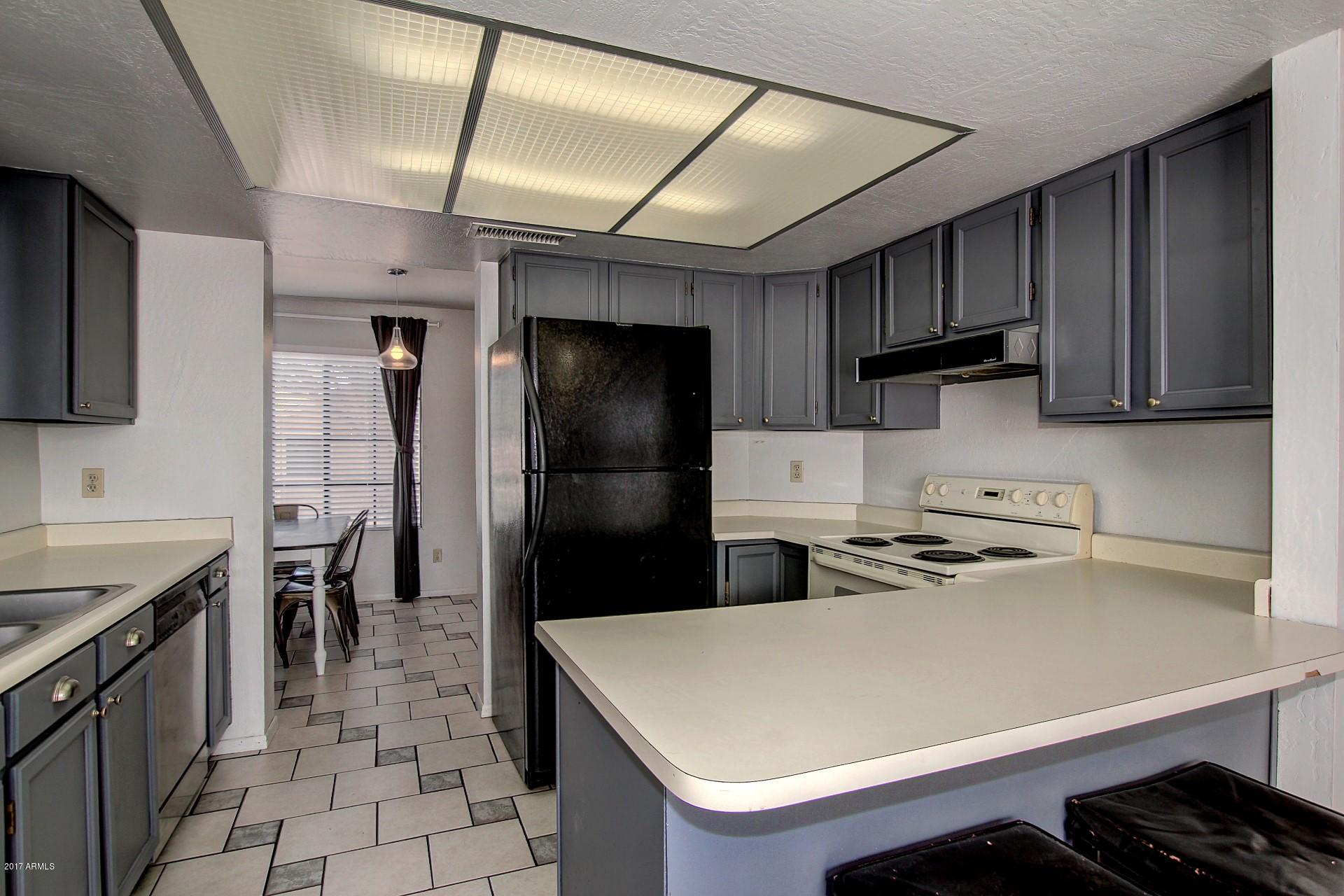 2455 East Broadway Road, Unit 93 Mesa, AZ 85204 - Photo 11 of 26 a kitchen with a refrigerator and a sink