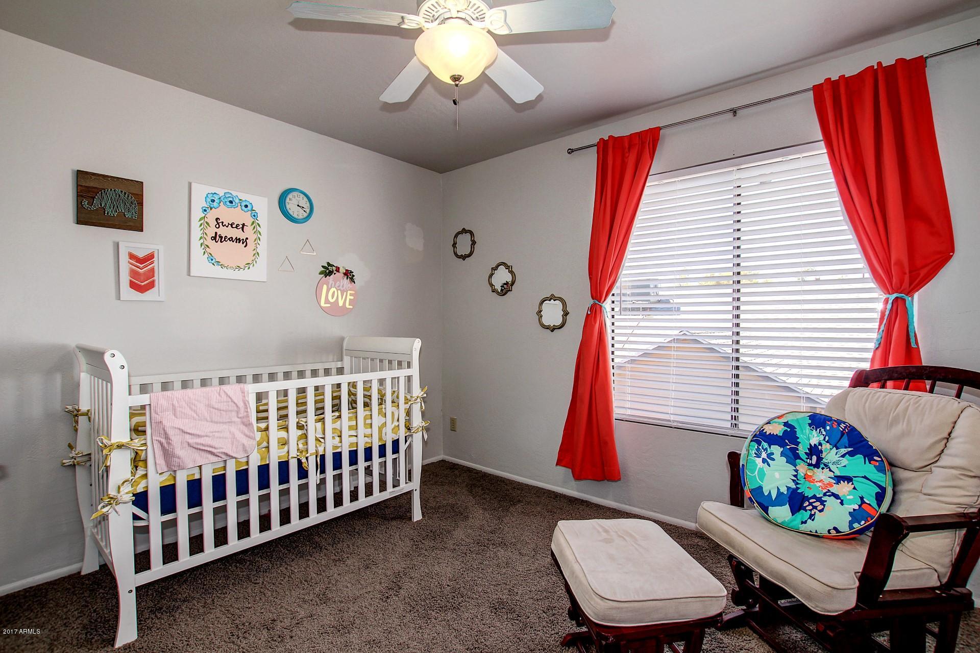2455 East Broadway Road, Unit 93 Mesa, AZ 85204 - Photo 18 of 26 a bedroom with a bed and a chair