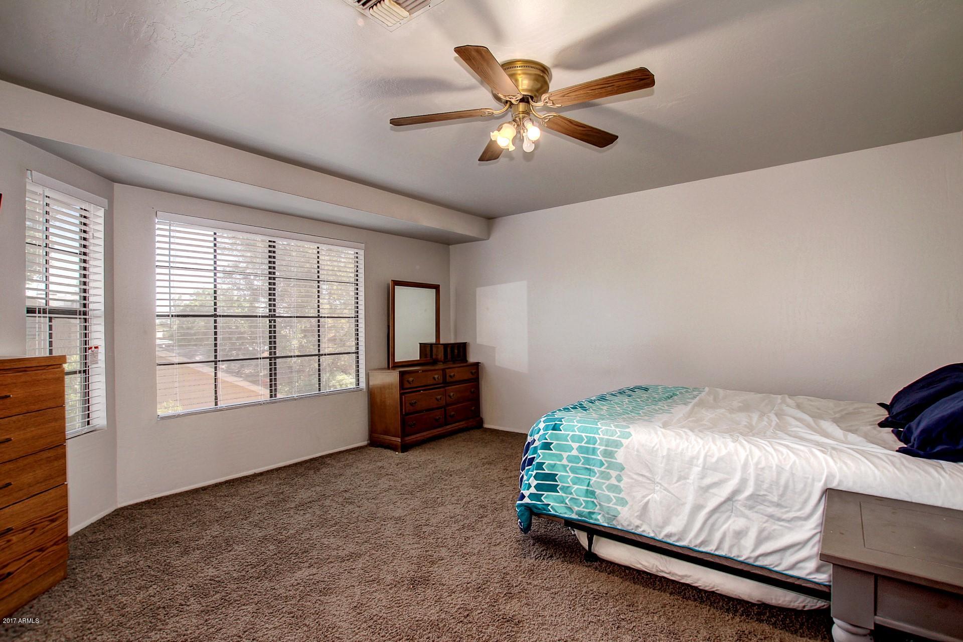 2455 East Broadway Road, Unit 93 Mesa, AZ 85204 - Photo 19 of 26 a bedroom with a bed and a window