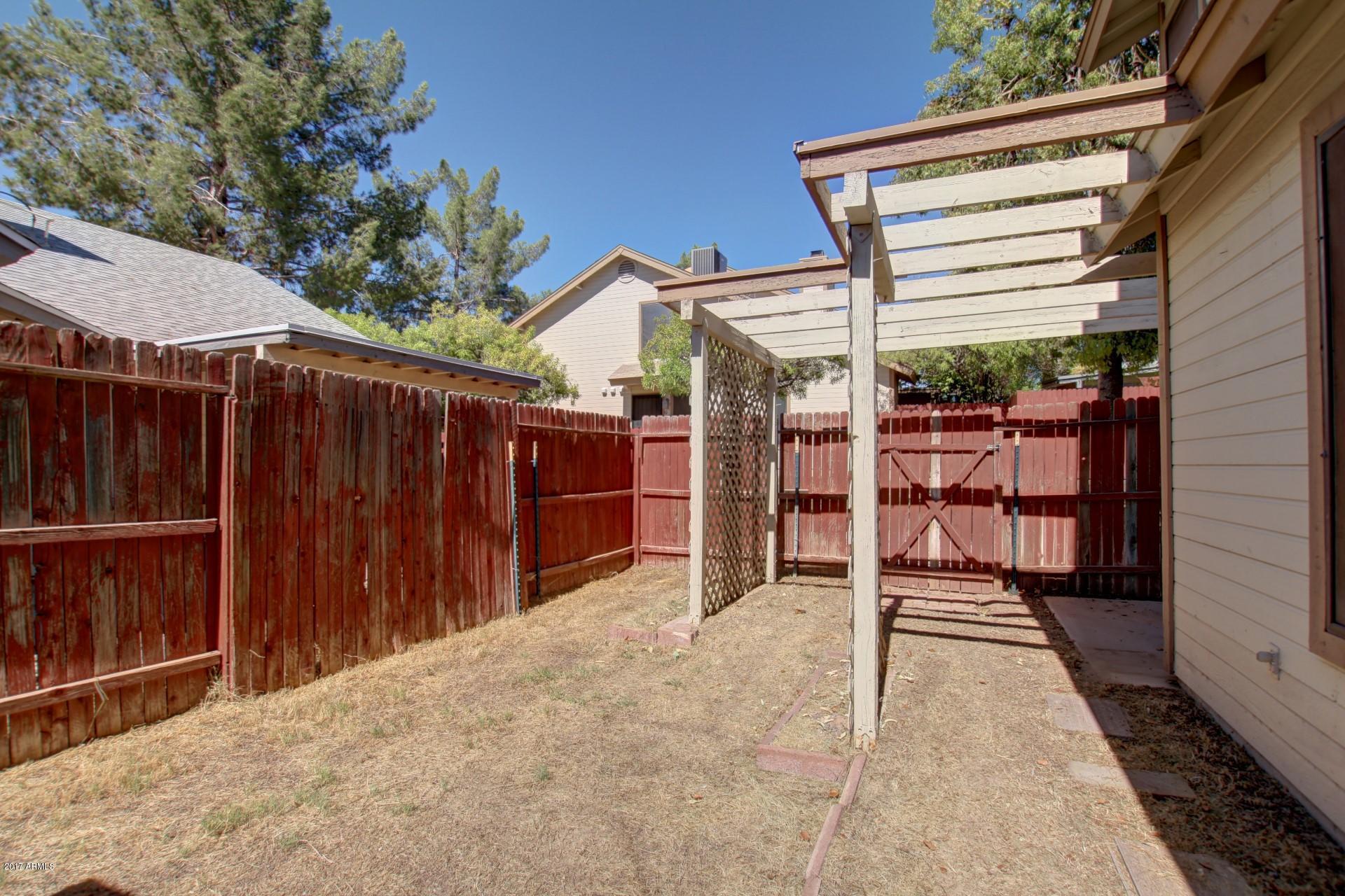 2455 East Broadway Road, Unit 93 Mesa, AZ 85204 - Photo 25 of 26 a view of a backyard with wooden fence