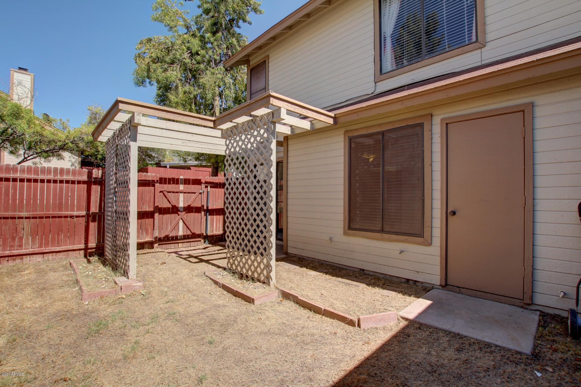 2455 East Broadway Road, Unit 93 Mesa, AZ 85204 - Photo 26 of 26 a view of a house with a door and wooden fence
