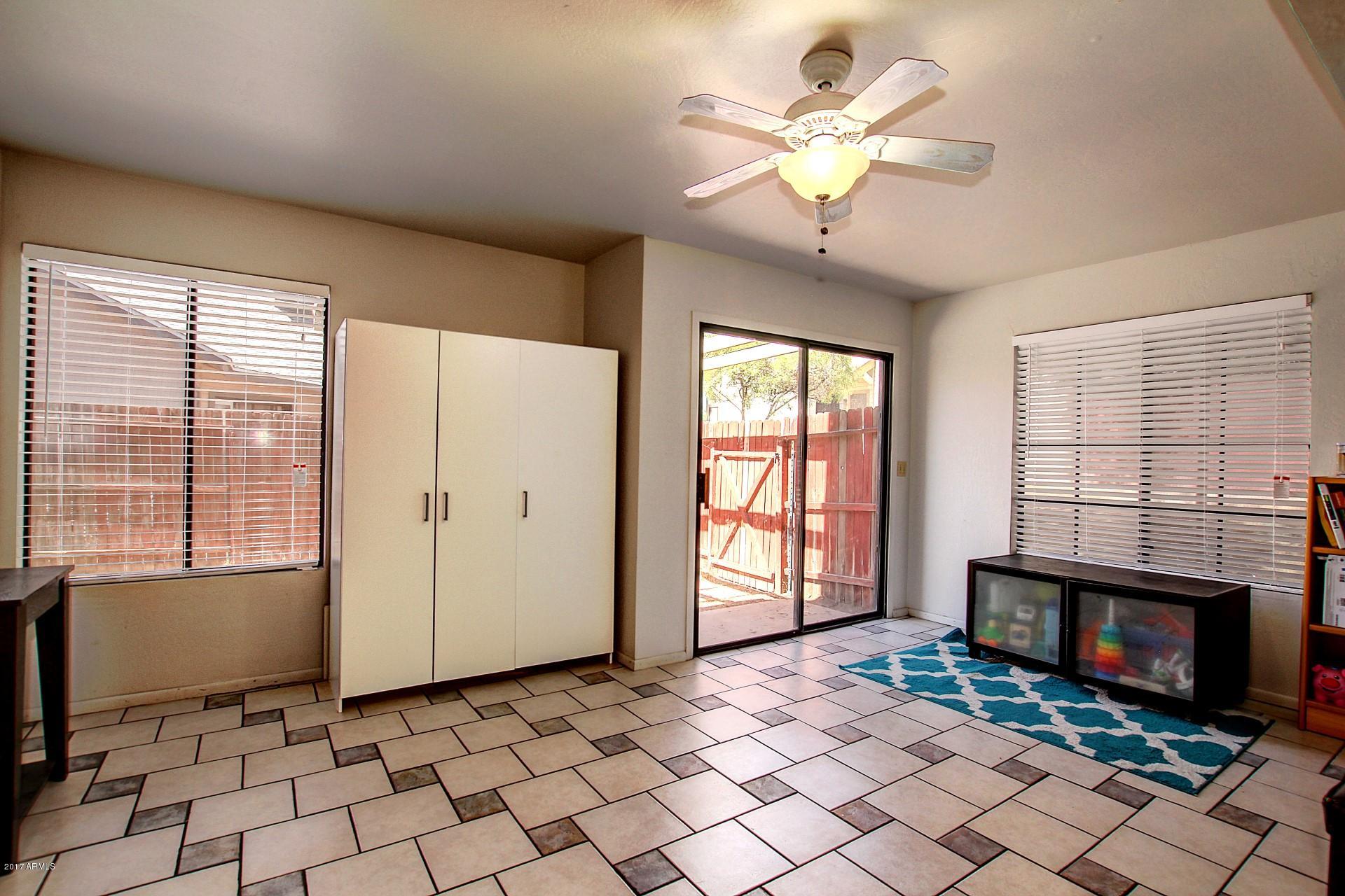 2455 East Broadway Road, Unit 93 Mesa, AZ 85204 - Photo 4 of 26 a view of an empty room with a fireplace and a window