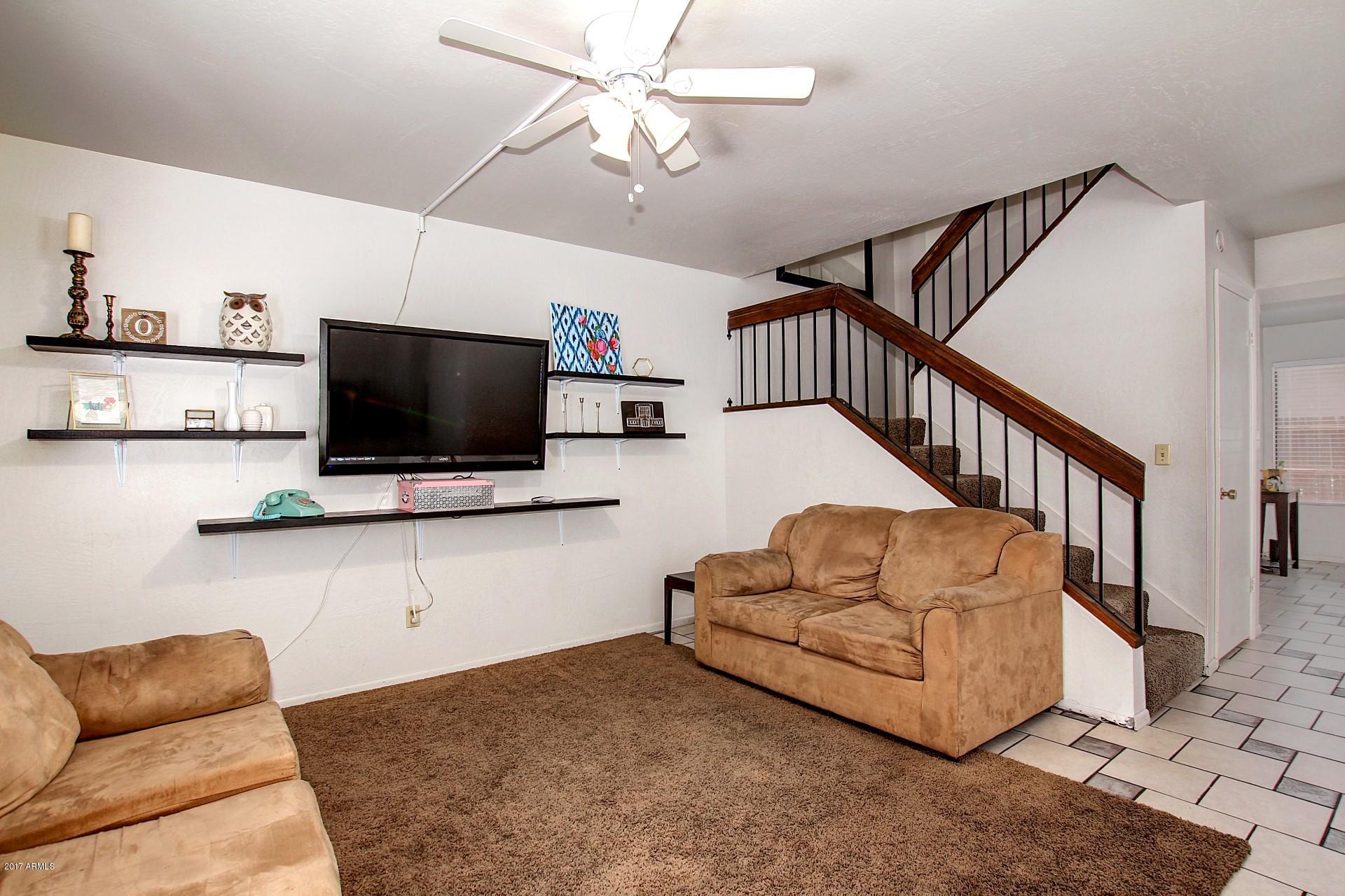2455 East Broadway Road, Unit 93 Mesa, AZ 85204 - Photo 7 of 26 a living room with furniture and a flat screen tv